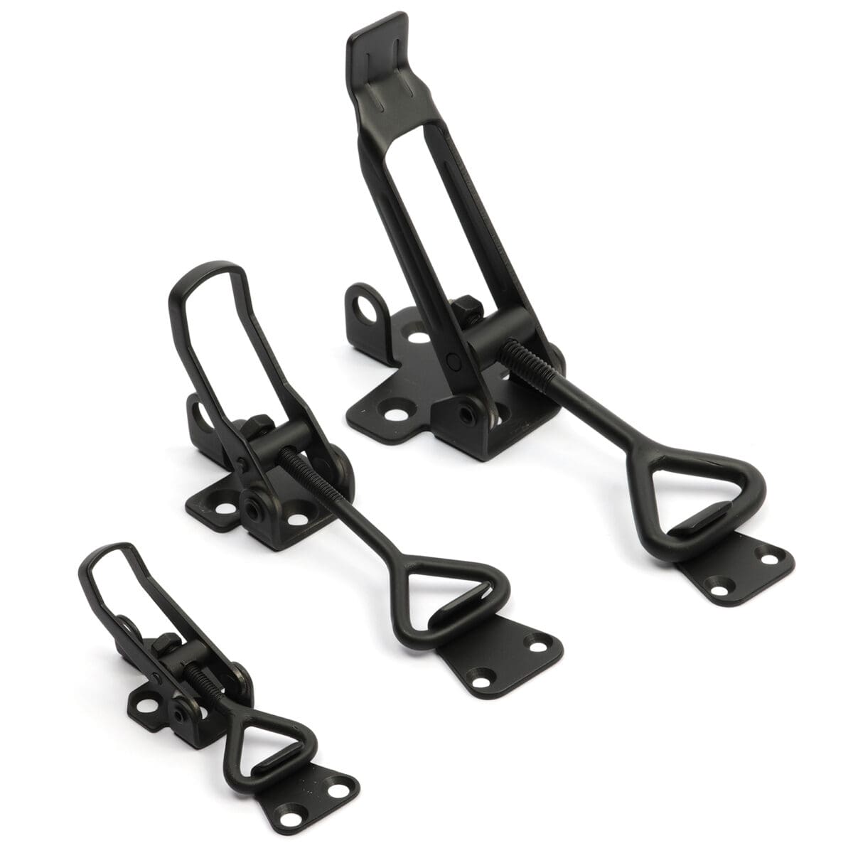 Three black metal toggle clamps of different sizes on a white background.